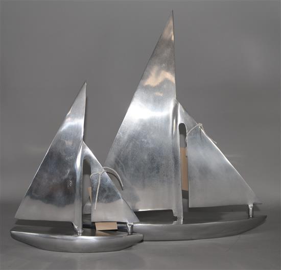 Two stylised aluminium models of yachts